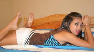 Sexy teen porn star stretches out on bed