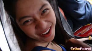 Filipina making funny face inside trike patrol