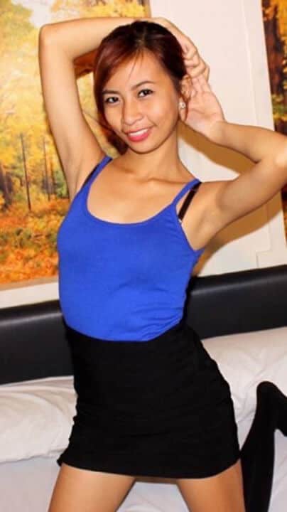 Nikka Asuncion poses on bed for camera