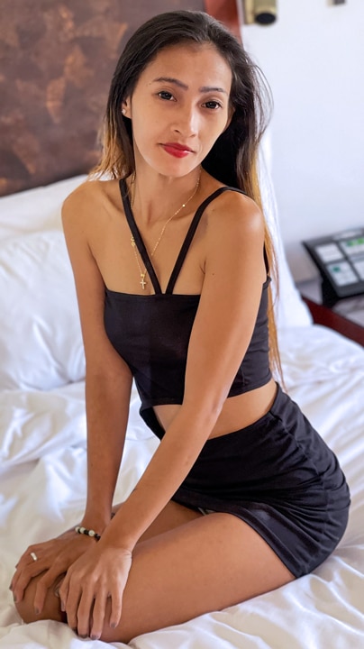 Mjane poses on motel bed