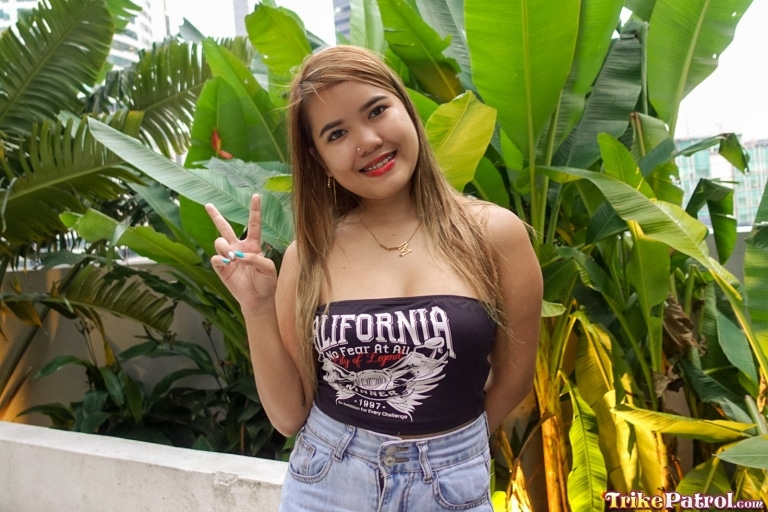 Cute Filipina flashes peace sign on set with trike patrol
