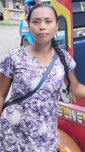 Filipina cougar Shae San poses for a photo next to a trike in the Philippines