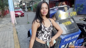 Pretty and petite Filipina poses next to a trike in Metro Manila