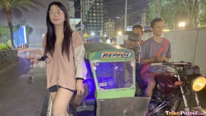 Pretty Filipina poses next to trike in the Philippines