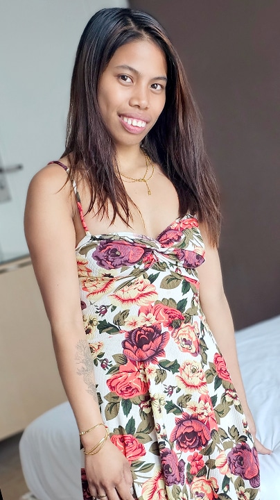 Exotic bargirl Ortsap Flores smiles in pretty dress