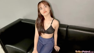 Cute Teen Porn model sits on black Casting Couch in black bra