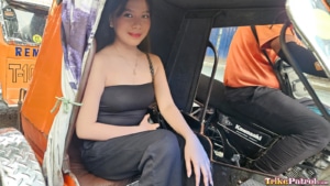 Sexy Asian babe joyfully sits on trike