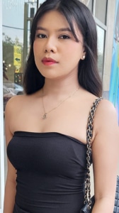 Tao Sibakan poses outside in a black dress