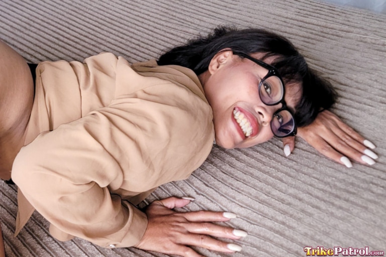 Pretty Asian milf shows manicure while posing in bed