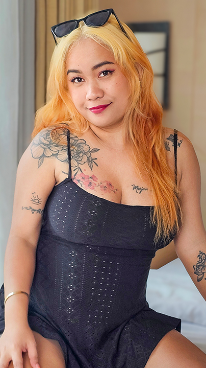 Blonde Filipina pornstar Queen Mia poses in black dress